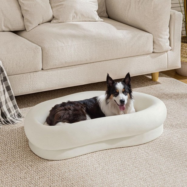 Eleganckie, owalne legowisko dla średnich i dużych psów, z grubymi rantami. Kremowy kolor, pasuje do nowoczesnego salonu.
