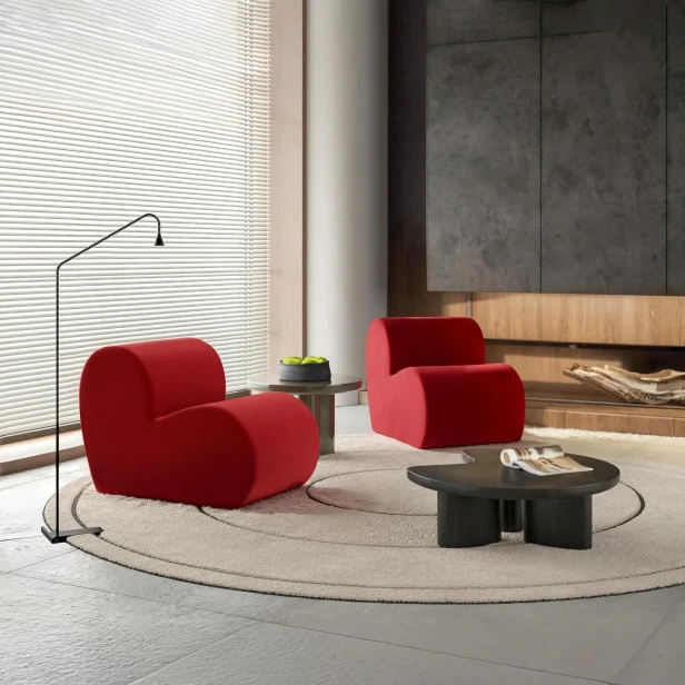 Aranżacja nowoczesnego, minimalistycznego salonu z dwoma designerskimi, czerwonymi fotelami modułowymi w kształcie serca.